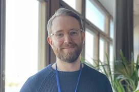 Joel in front of the window of Epinova's office